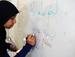 Muslim Students Association president Salma Khan demonstrating how to write in Arabic. Arabic writing lessons are one of the many unique activities the MSA sponsors. Photo credit: ALEXANDRA MADAR