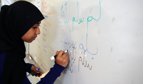 Muslim Students Association president Salma Khan demonstrating how to write in Arabic. Arabic writing lessons are one of the many unique activities the MSA sponsors. Photo credit: ALEXANDRA MADAR